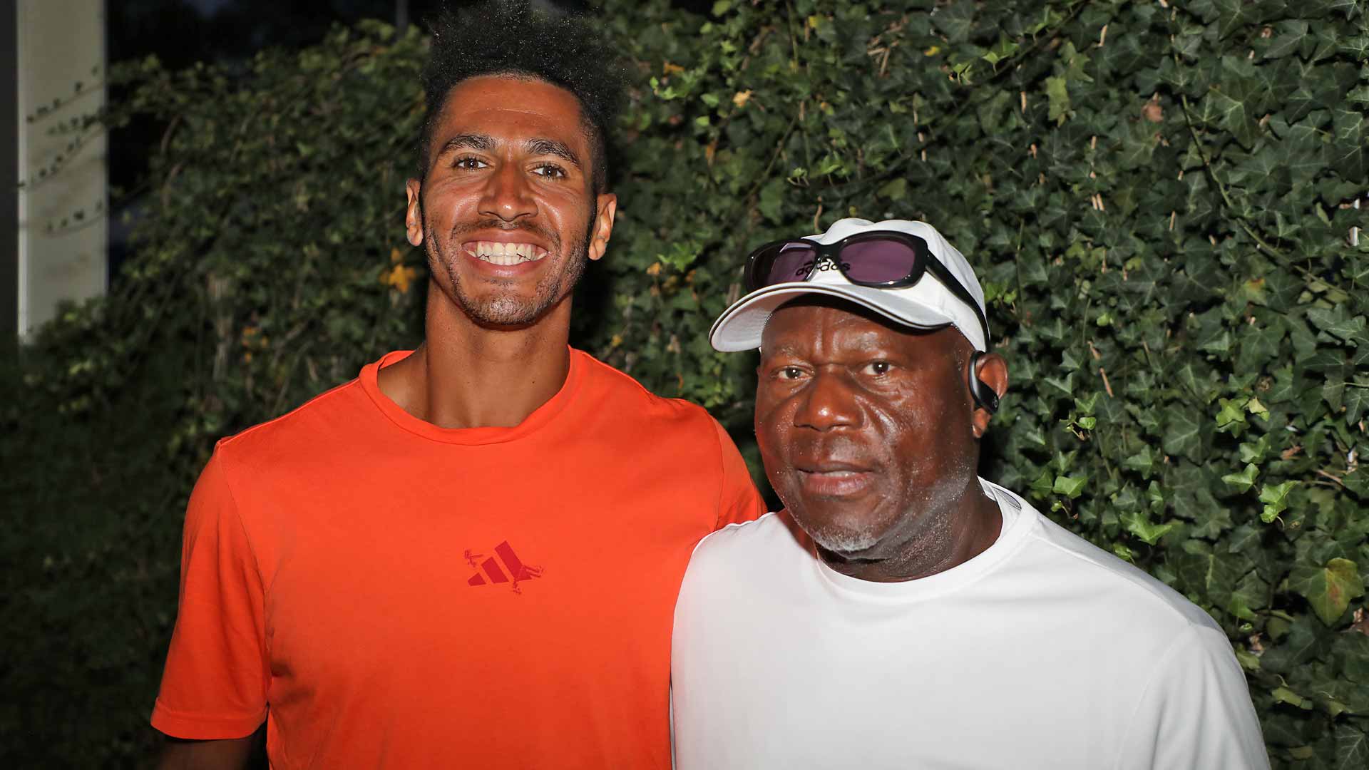 Michael Mmoh poses for a photo with his father and former professional, Tony Mmoh, in Washington.