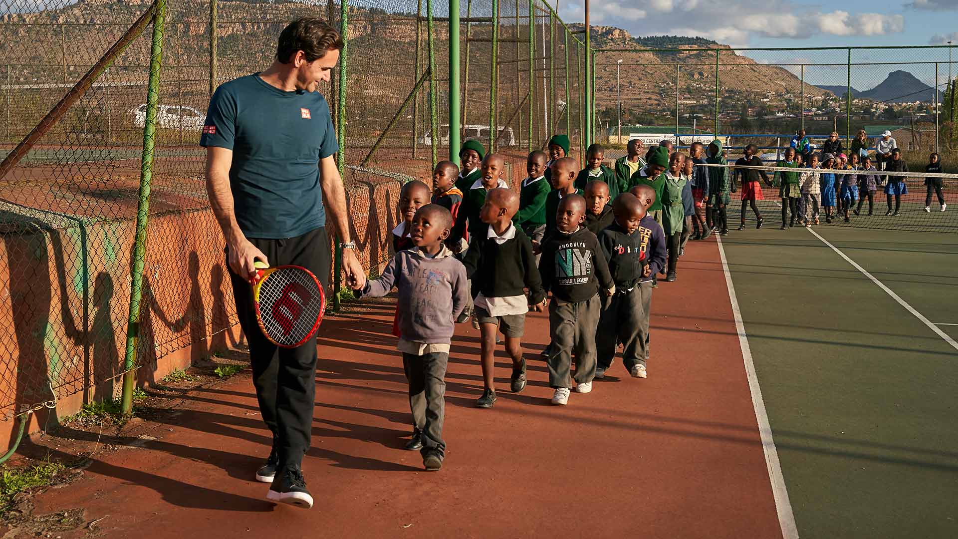 Roger Federer with some of the youngest players from the Lesotho Lawn Tennis Association in Maseru, Lesotho, on 16 May 2023.