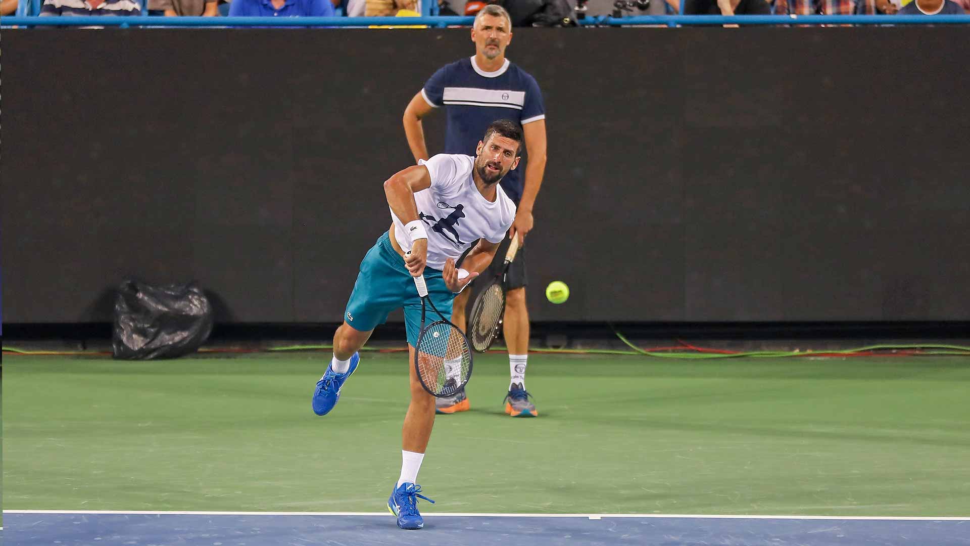 Novak Djokovic works on his serve under the watchful eye of coach Goran Ivanisevic.