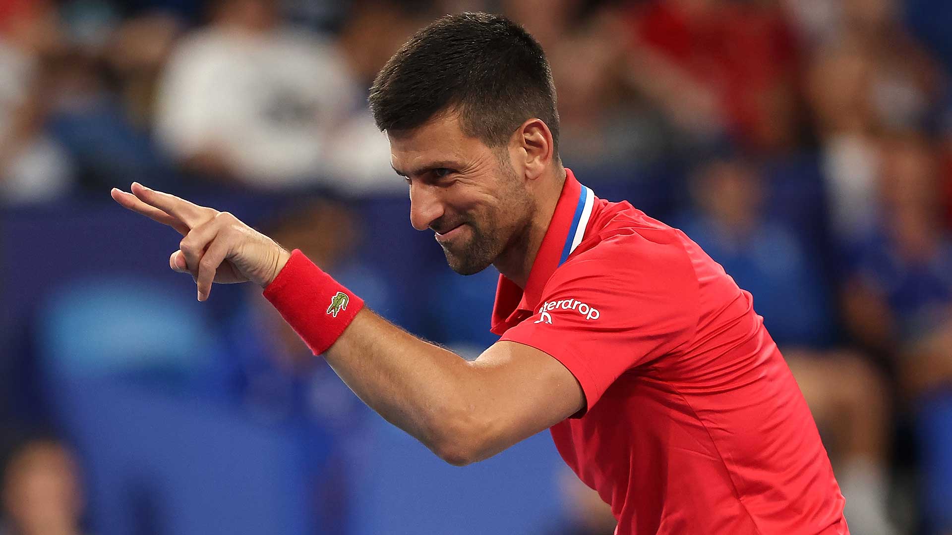 Novak Djokovic jokingly points at Zheng Qinwen during Serbia's United Cup tie with China on Sunday.
