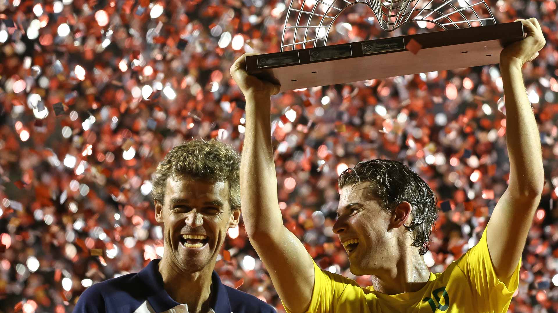 Former World No. 1 Gustavo Kuerten and Dominic Thiem share a laugh at the 2017 Rio Open trophy ceremony.