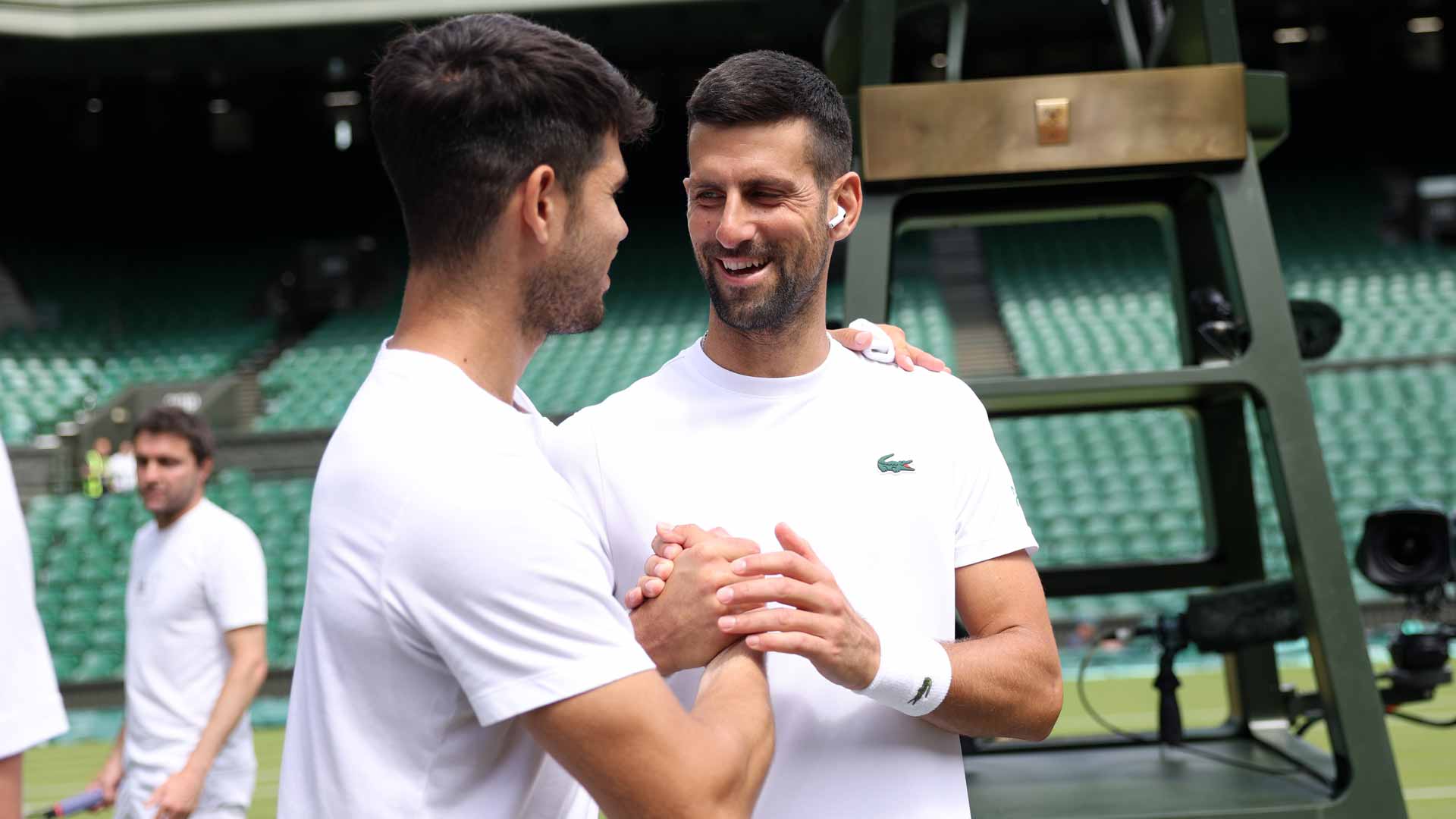 Carlos Alcaraz and Novak Djokovic embrace Thursday at Wimbledon.