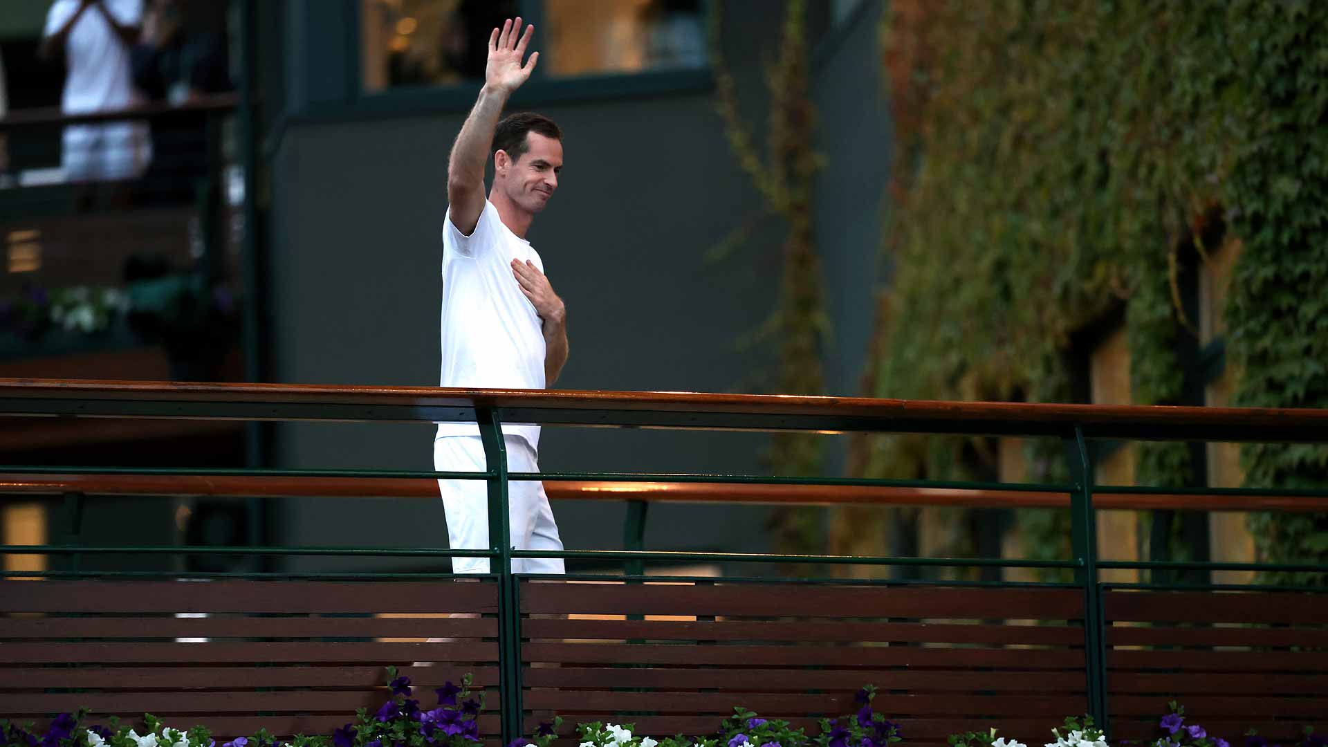 Andy Murray waves to fans after his men's doubles match Thursday evening at Wimbledon.