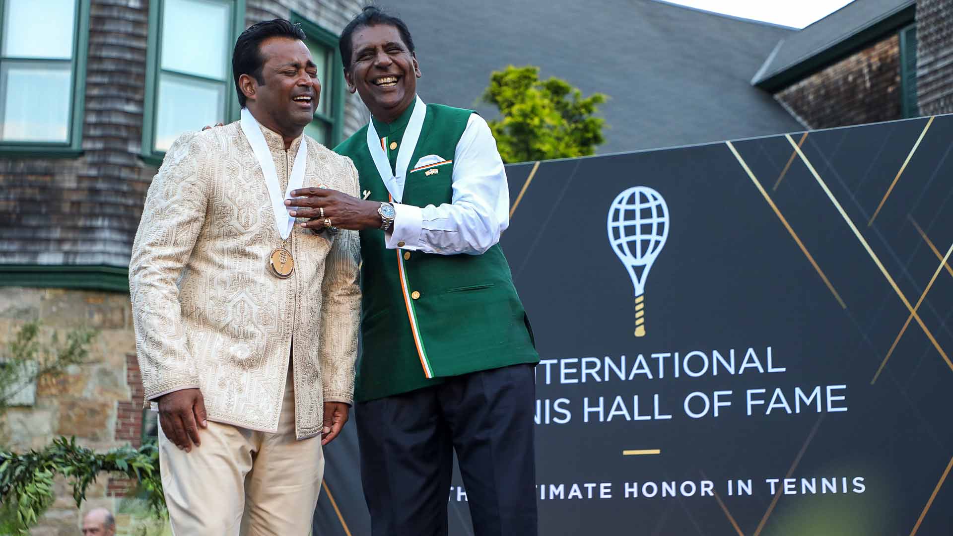 Leander Paes and Vijay Amritraj share a laugh following their induction into the International Tennis Hall of Fame.