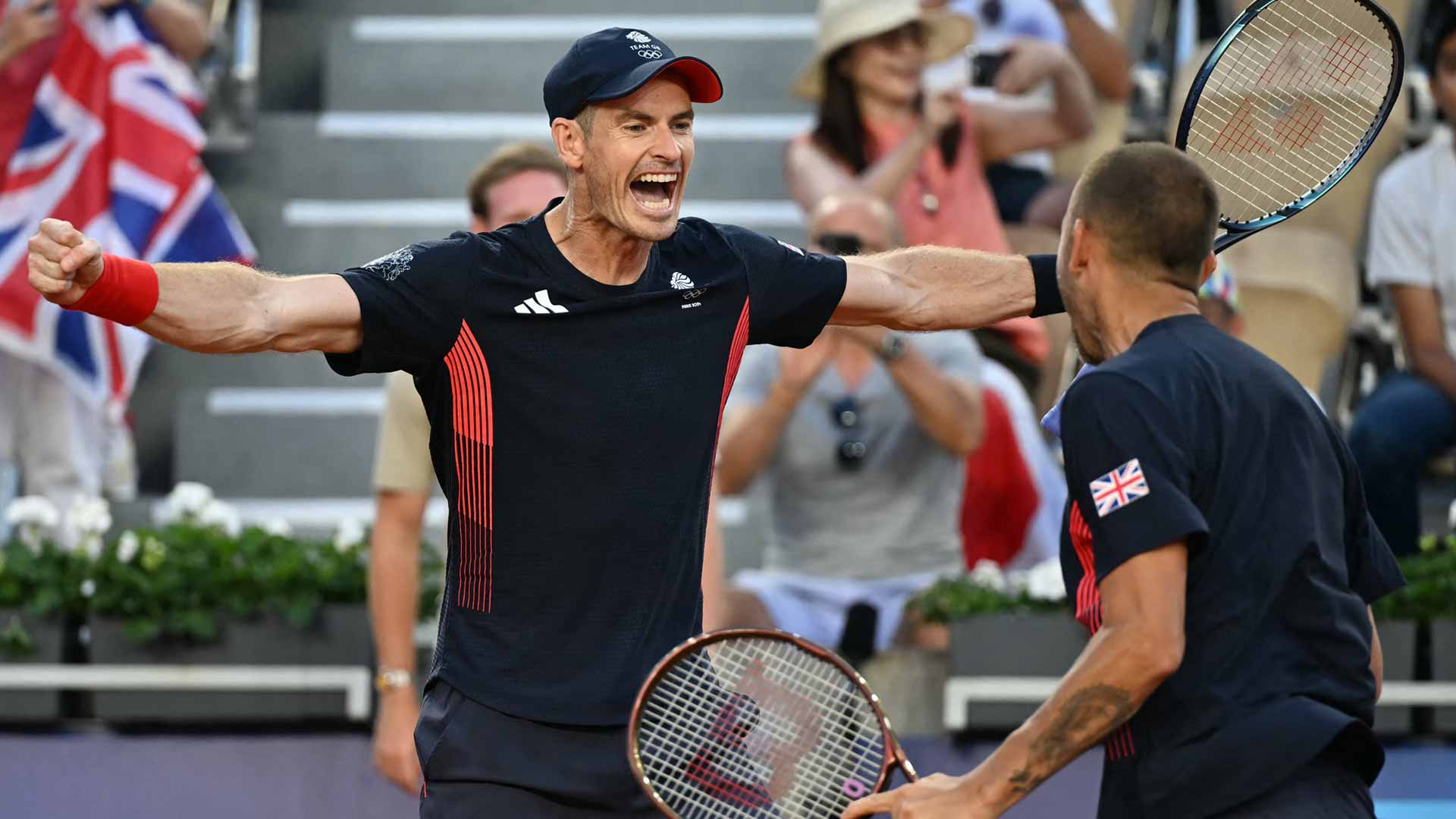Andy Murray and Daniel Evans celebrate after rallying past Taro Daniel and Kei Nishikori in Paris.