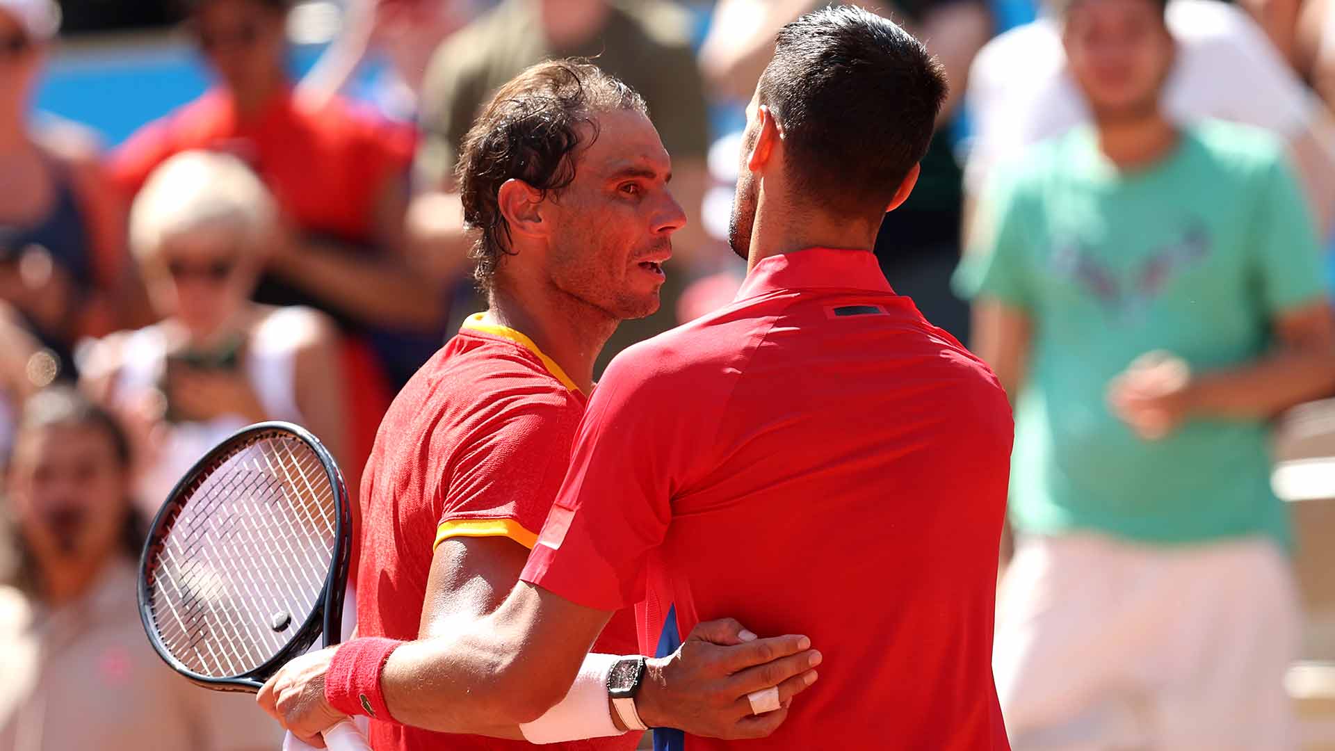 Rafael Nadal and Novak Djokovic embrace after their 60th career meeting.