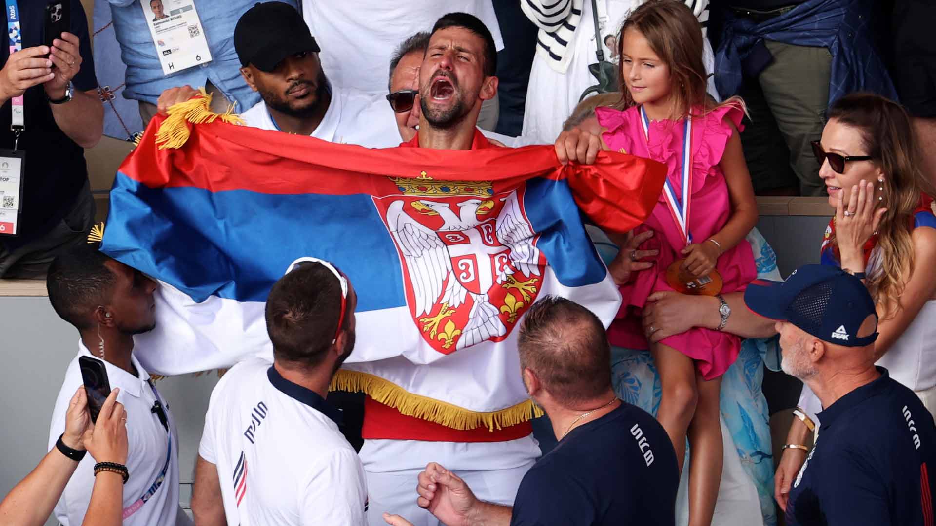 Novak Djokovic celebrates in his player box after defeating Carlos Alcaraz for the Olympic gold medal Sunday.