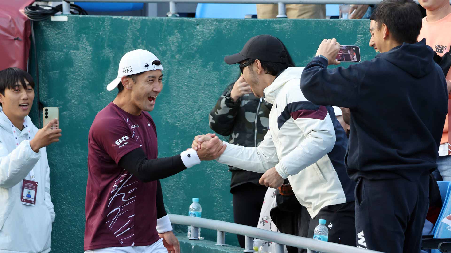 <a href='https://www.atptour.com/en/players/sho-shimabukuro/sy67/overview'>Sho Shimabukuro</a> celebrates with his team after winning the Seoul Challenger.